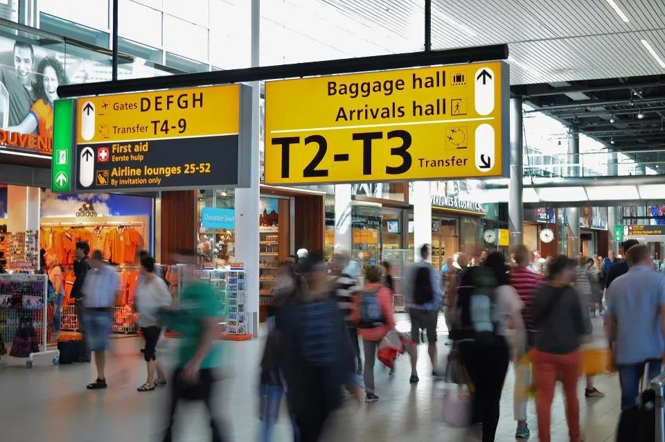Busy airport arrivals hall with baggage hall signs